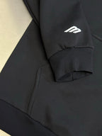 Black Balenciaga zip-up hoodie sleeve cuff with white logo detail