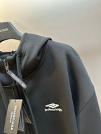 Black Balenciaga zip-up hoodie sleeve with small chest logo detail