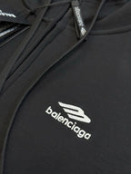 Black Balenciaga zip-up hoodie with front zipper and logo on chest