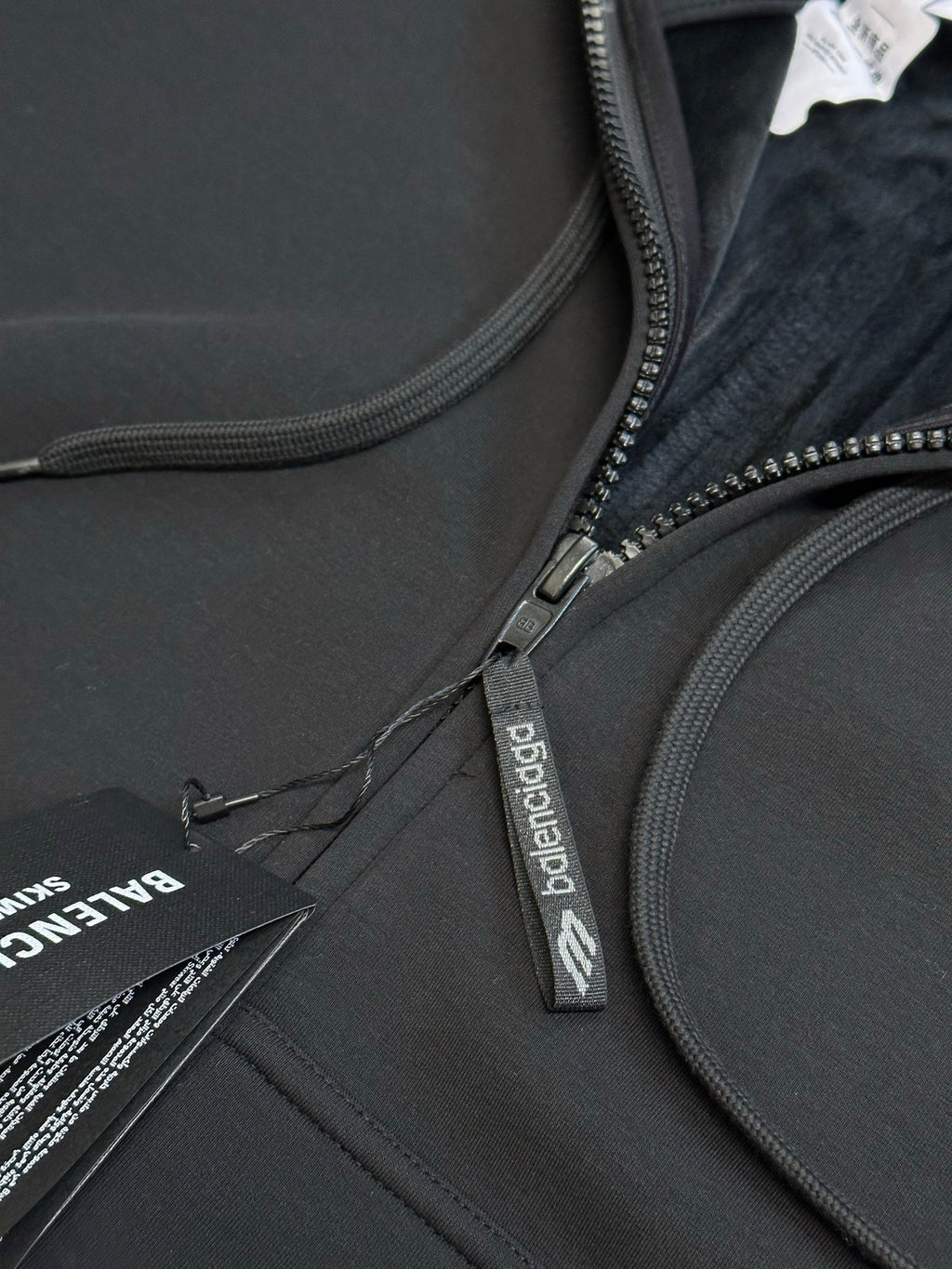 Black Balenciaga zip-up hoodie close-up of front zipper and drawstring cord