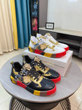 Luxury Versace sneakers, black with gold graphic prints, red and yellow rubber sole accents