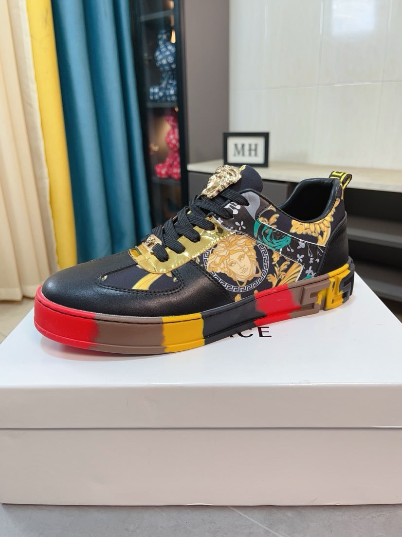 Luxury Versace lace-up sneakers, black upper with gold detailing and bold red-yellow sole