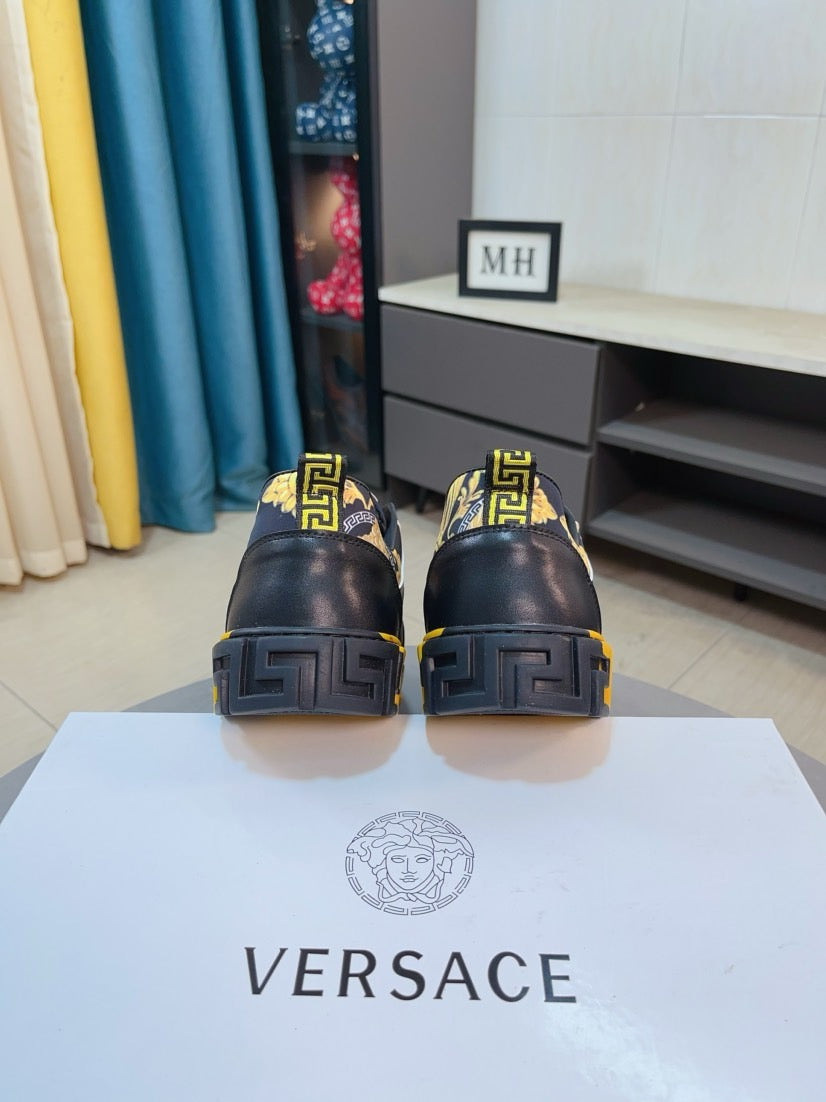 Luxury Versace sneakers rear view, dark heel with gold accents and textured tread sole