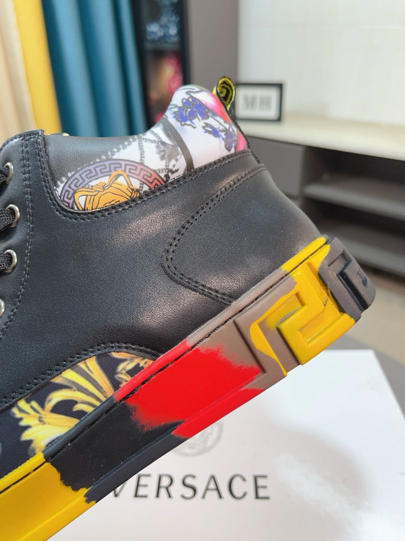 Versace high-top sneaker close-up, dark gray leather with baroque collar and yellow/red detail