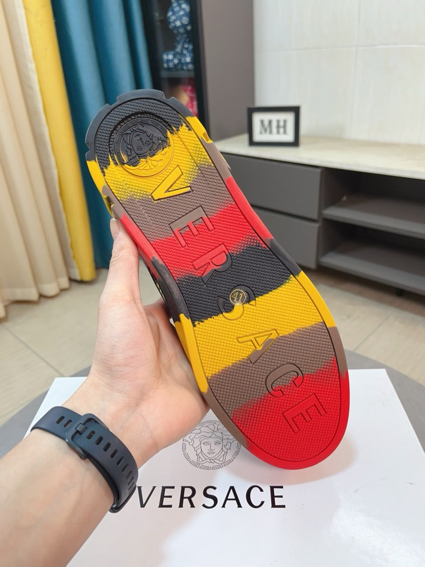 Versace sneaker outsole view, textured tread with yellow, gray, and red patterning