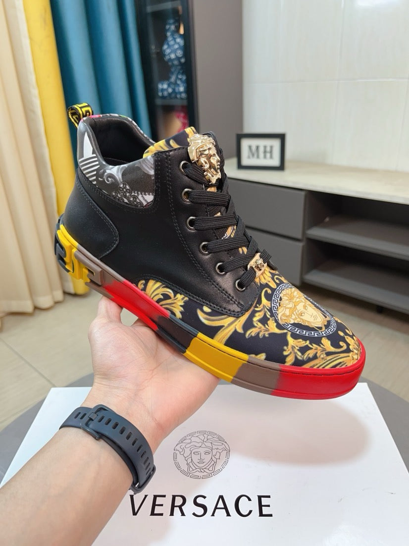Versace high-top sneakers on hand, black with gold crest panel, red and yellow outsole