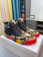 Versace high-top sneakers pair, black uppers with gold/blue baroque print and red/yellow soles