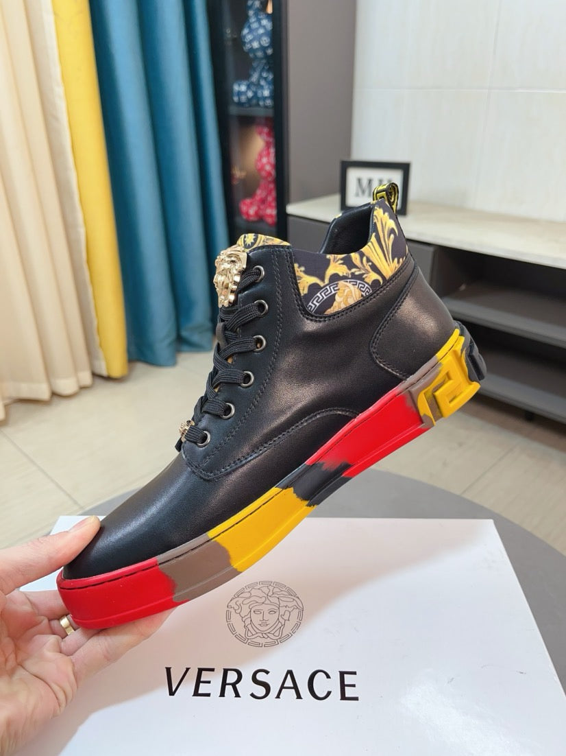 Black high-top sneaker on hand with patterned side panel, lace-up, red and yellow outsole