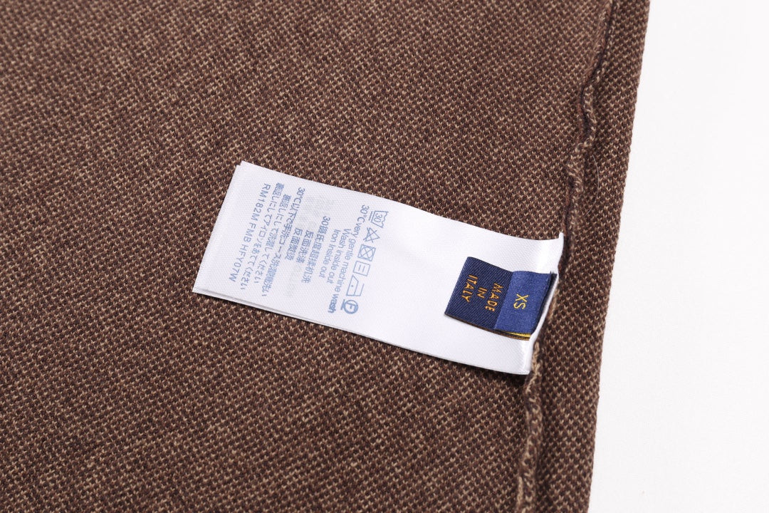 Louis Vuitton fabric label on brown check knit shirt near side seam