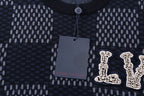 Close-up of check-pattern T-shirt neckline and LV logo applique with hanging tag