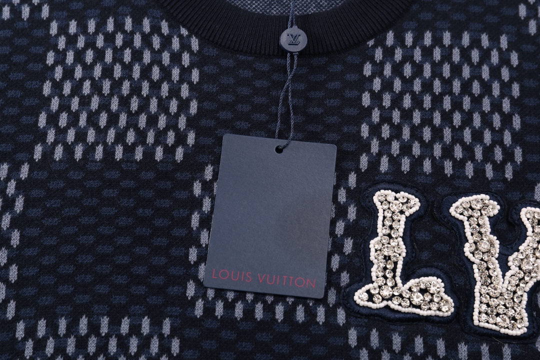 Close-up of check-pattern T-shirt neckline and LV logo applique with hanging tag