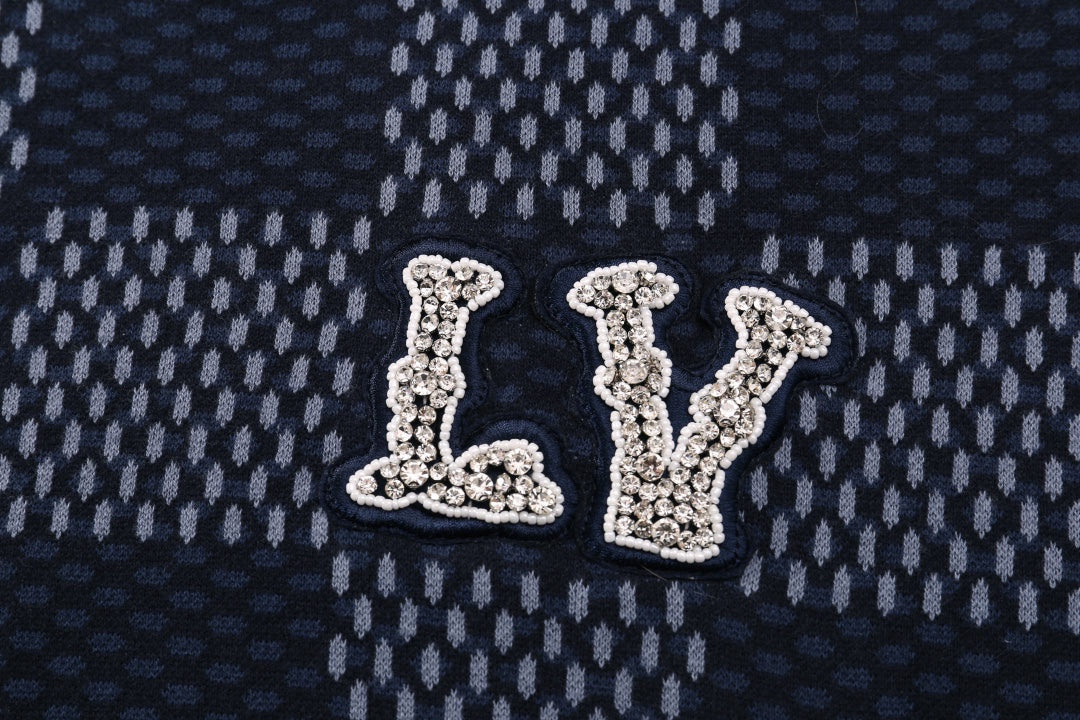 Close-up of LV logo applique on a check-pattern short-sleeve T-shirt
