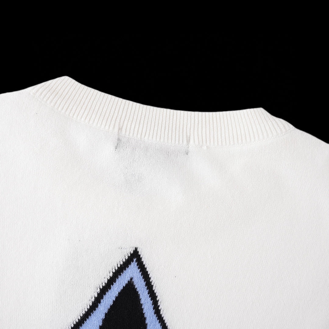 White T-shirt back neck seam with blue star logo partially shown