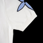 White T-shirt with partial blue star motif and ribbed sleeve cuff