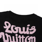 Louis Vuitton black T-shirt with large pink script graphic across the chest