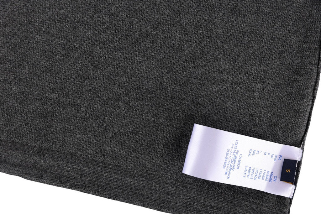 Dark gray T-shirt hem with blue fabric tag