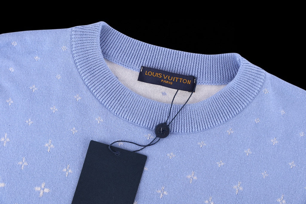 Light blue crewneck short-sleeve shirt with ribbed collar and brand label at the neckline