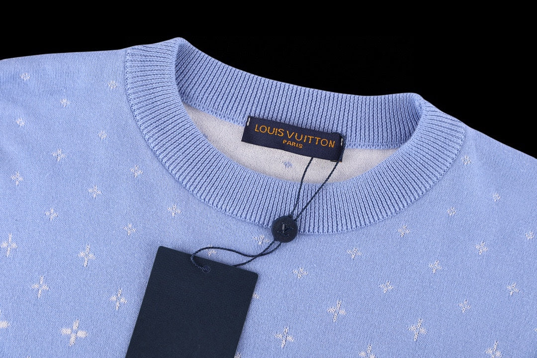 Light blue crewneck short-sleeve shirt with ribbed collar and brand label at the neckline