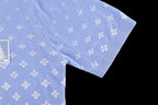 Light blue short-sleeve shirt showing side seam and curved hem with white repeating pattern