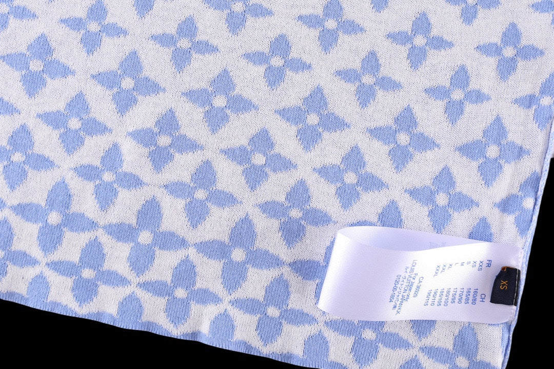 Light blue fabric with repeating white pattern and care label stitched near the hem