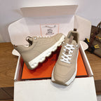 Beige lace-up sneakers with chunky white tread sole, side and front angle pair.