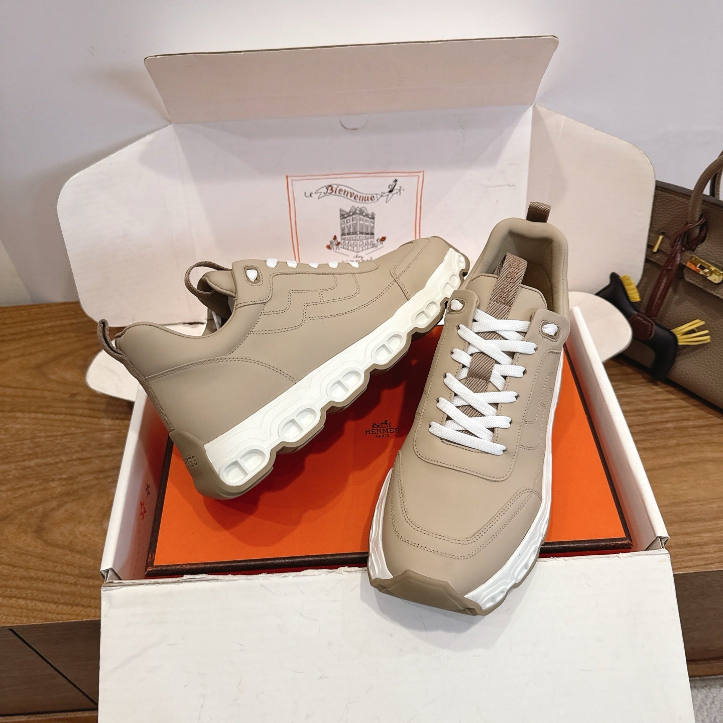 Beige lace-up sneakers with chunky white tread sole, side and front angle pair.