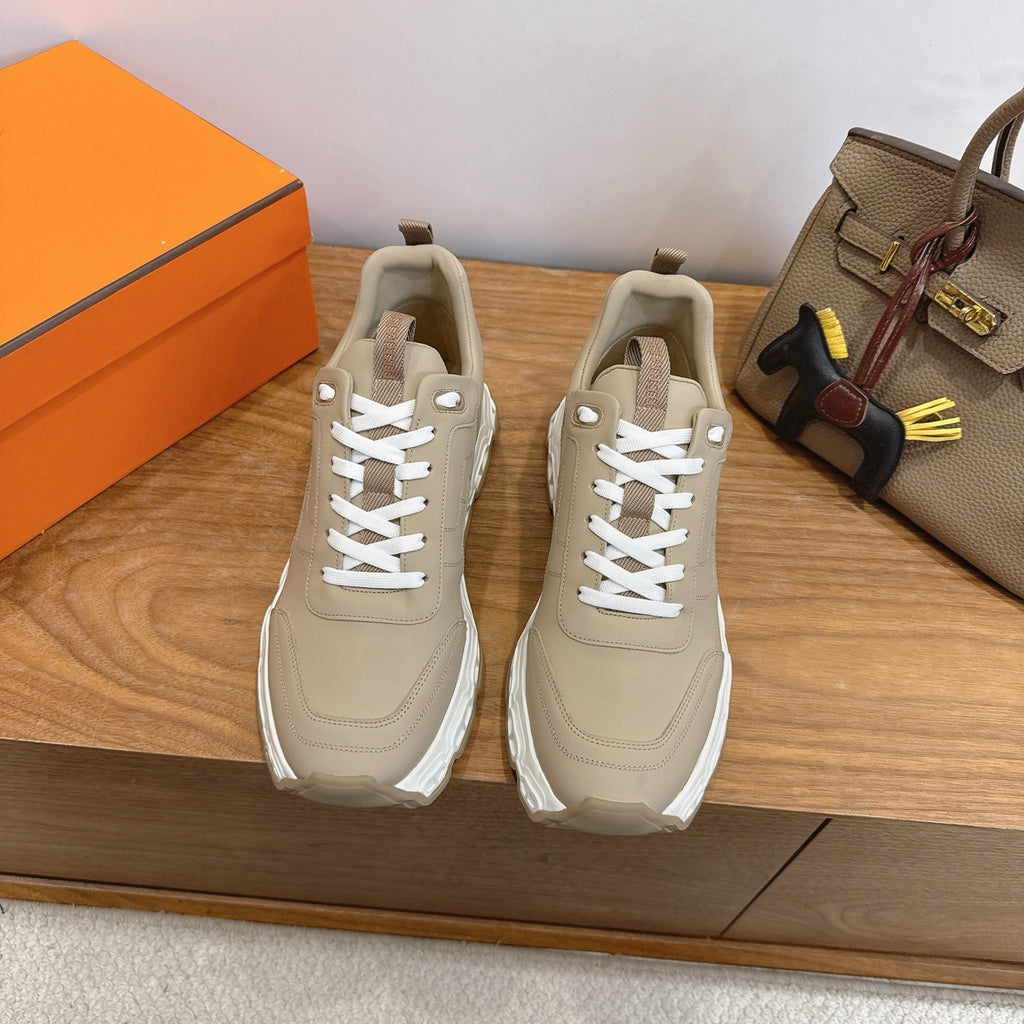 Beige lace-up sneakers with thick white sole, front view pair.