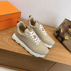Beige lace-up sneakers with white molded sole, side view pair on display.