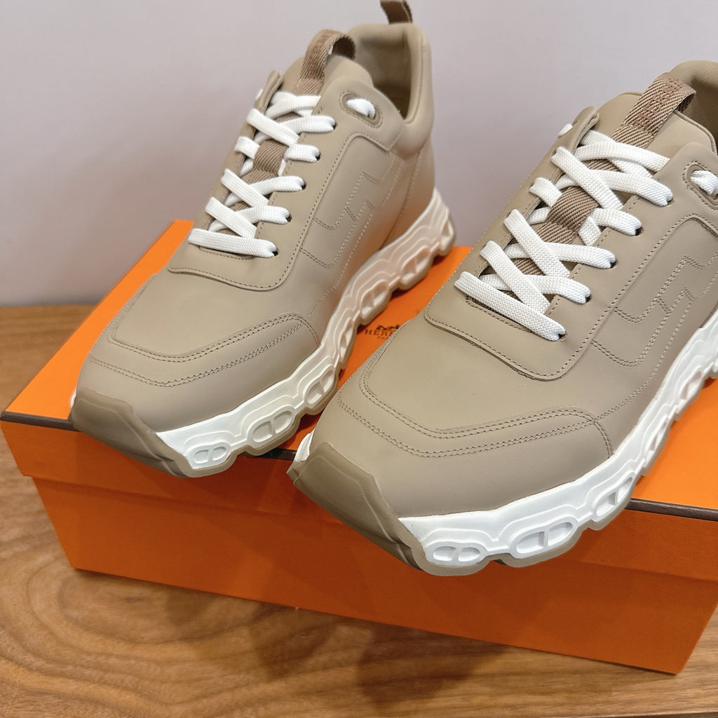 Beige lace-up sneakers with white laces and padded collars, close-up pair.