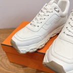White lace-up sneakers, close-up of laces and cushioned sole, Hermes style