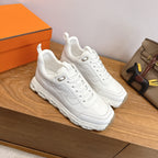 White lace-up sneakers, chunky sole and rubber tread, Hermes style