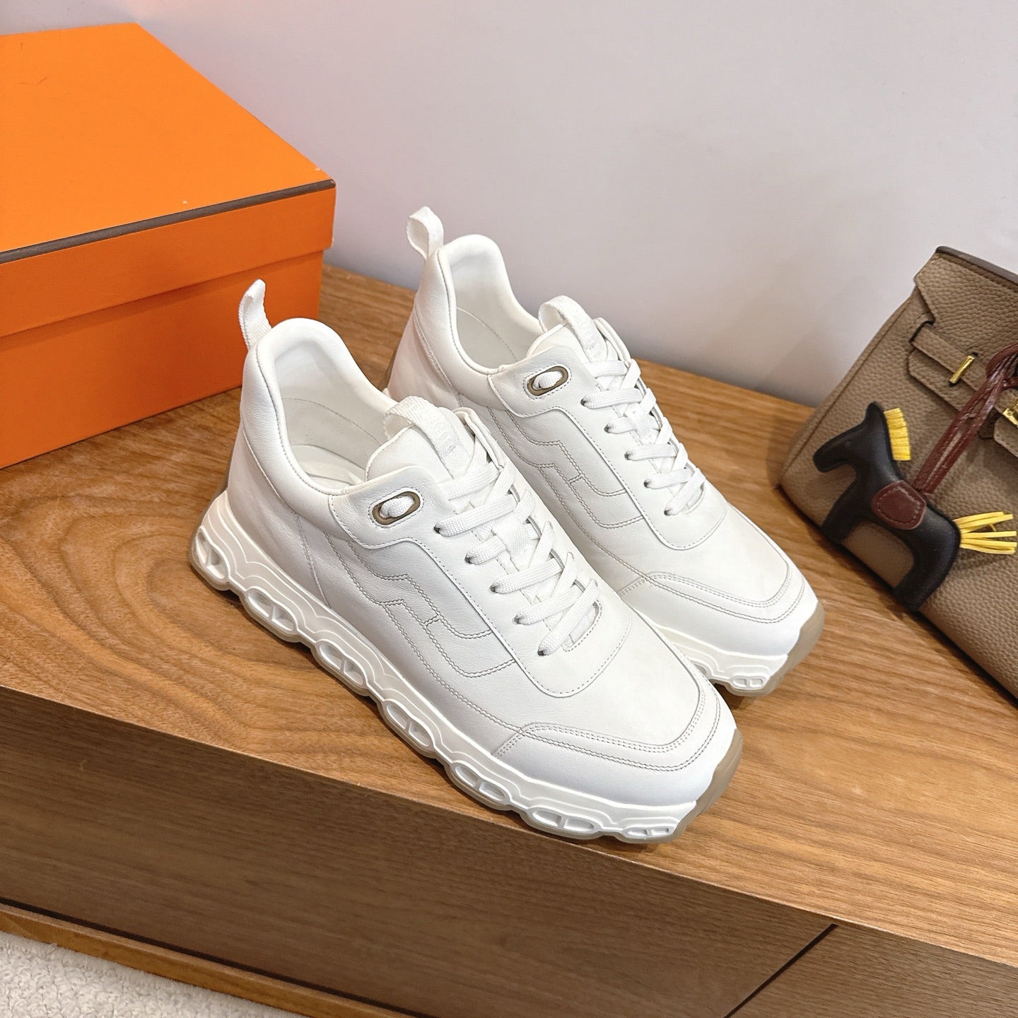 White lace-up sneakers, chunky sole and rubber tread, Hermes style