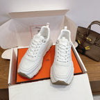White lace-up sneakers in open box, chunky sole, Hermes style