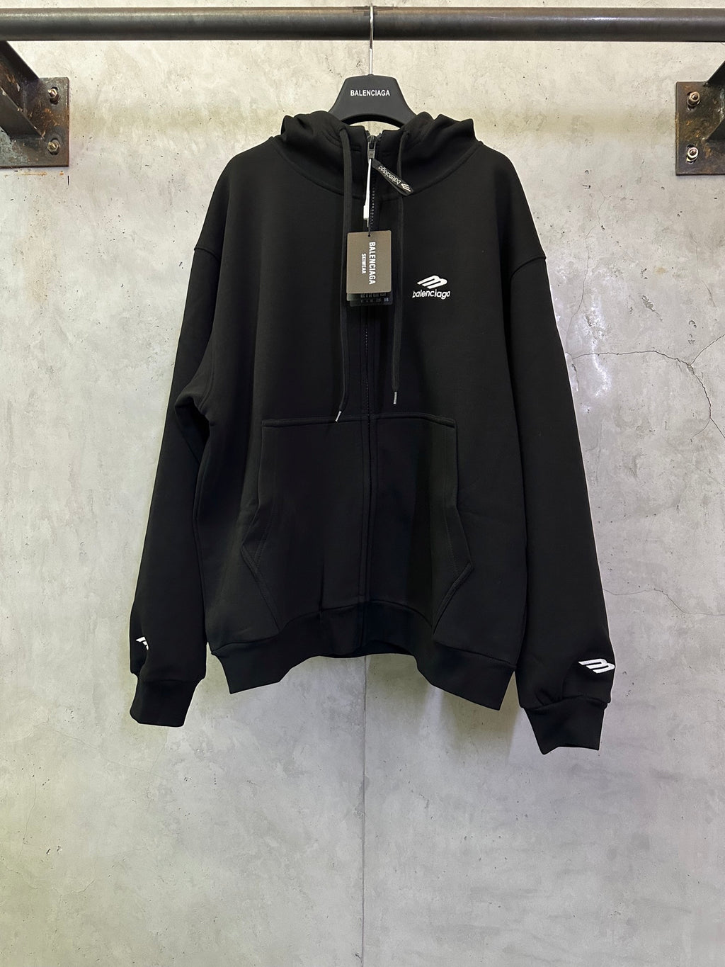 Balenciaga black zip-up hoodie with drawstring hood and front pockets