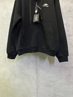 Balenciaga black zip-up hoodie with front zipper and kangaroo pocket detail.