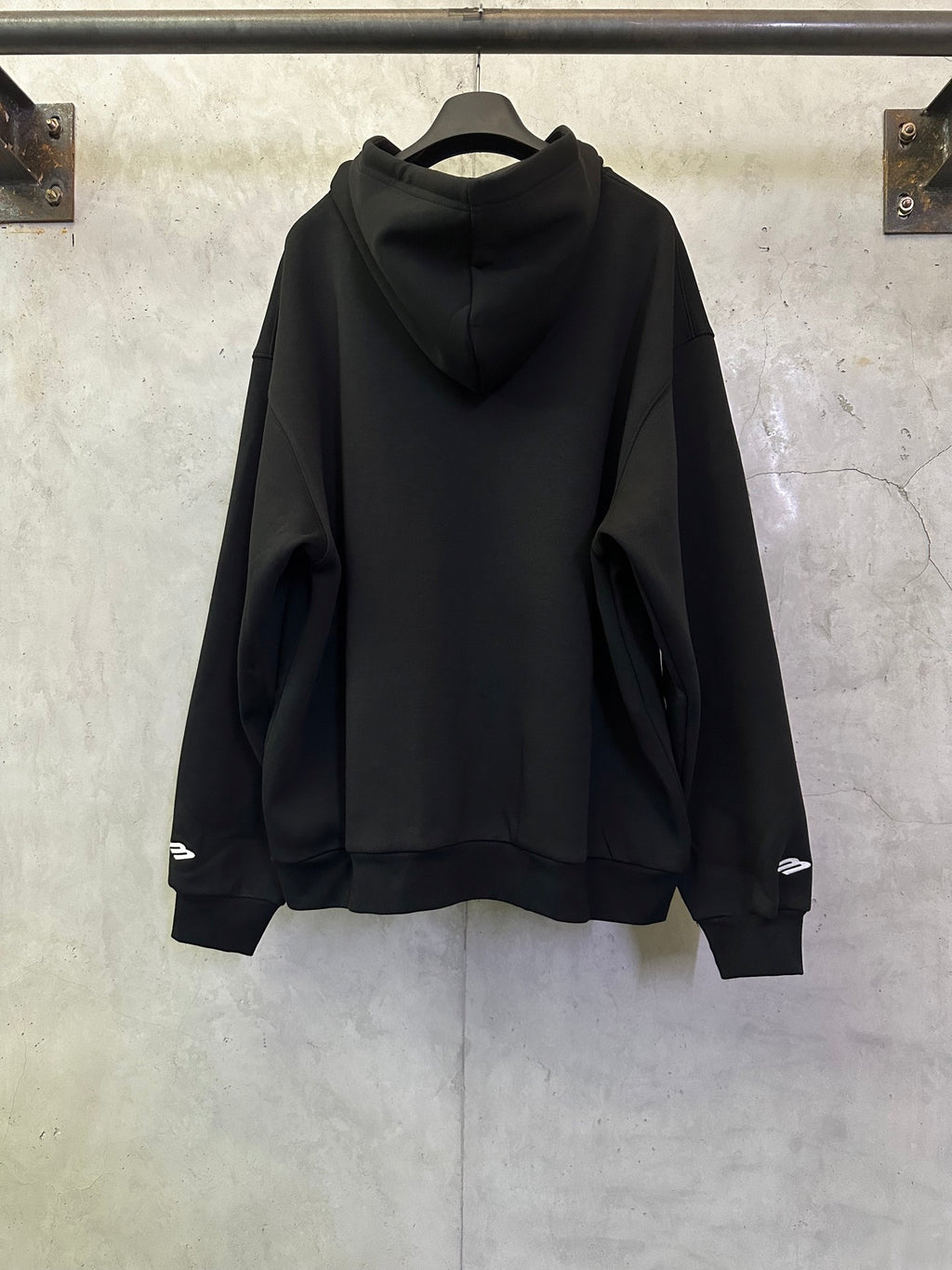 Balenciaga black zip-up hoodie, rear view with hood and long sleeves.