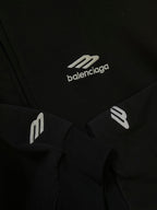 Balenciaga black hoodie with white balenciaga logo print and branded sleeve detail.