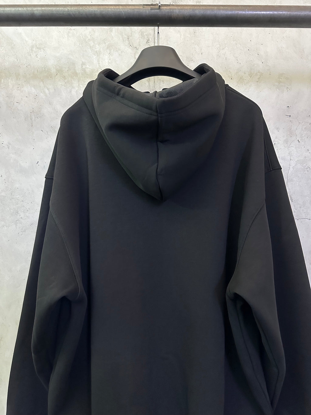 Balenciaga black zip-up hoodie back view with center hood seam