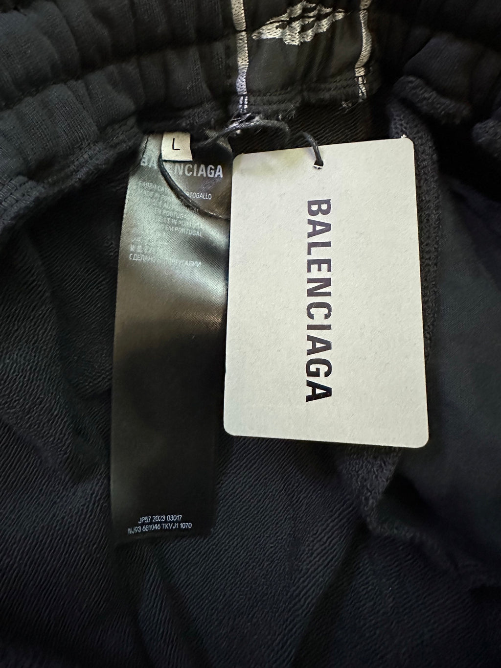 Black track pants with Balenciaga logo waistband and size tag