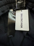Black track pants with Balenciaga logo waistband and size tag