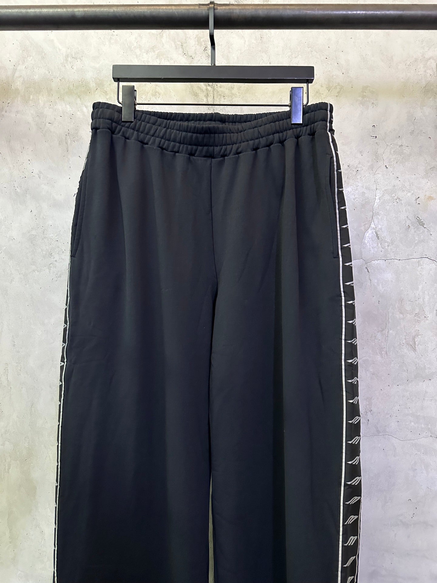Navy wide-leg track pants with elastic waistband and side stripe detail