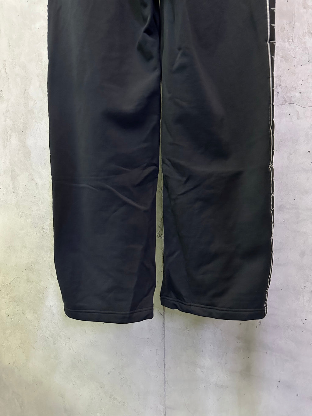 Navy loose-leg track pants with elastic waistband