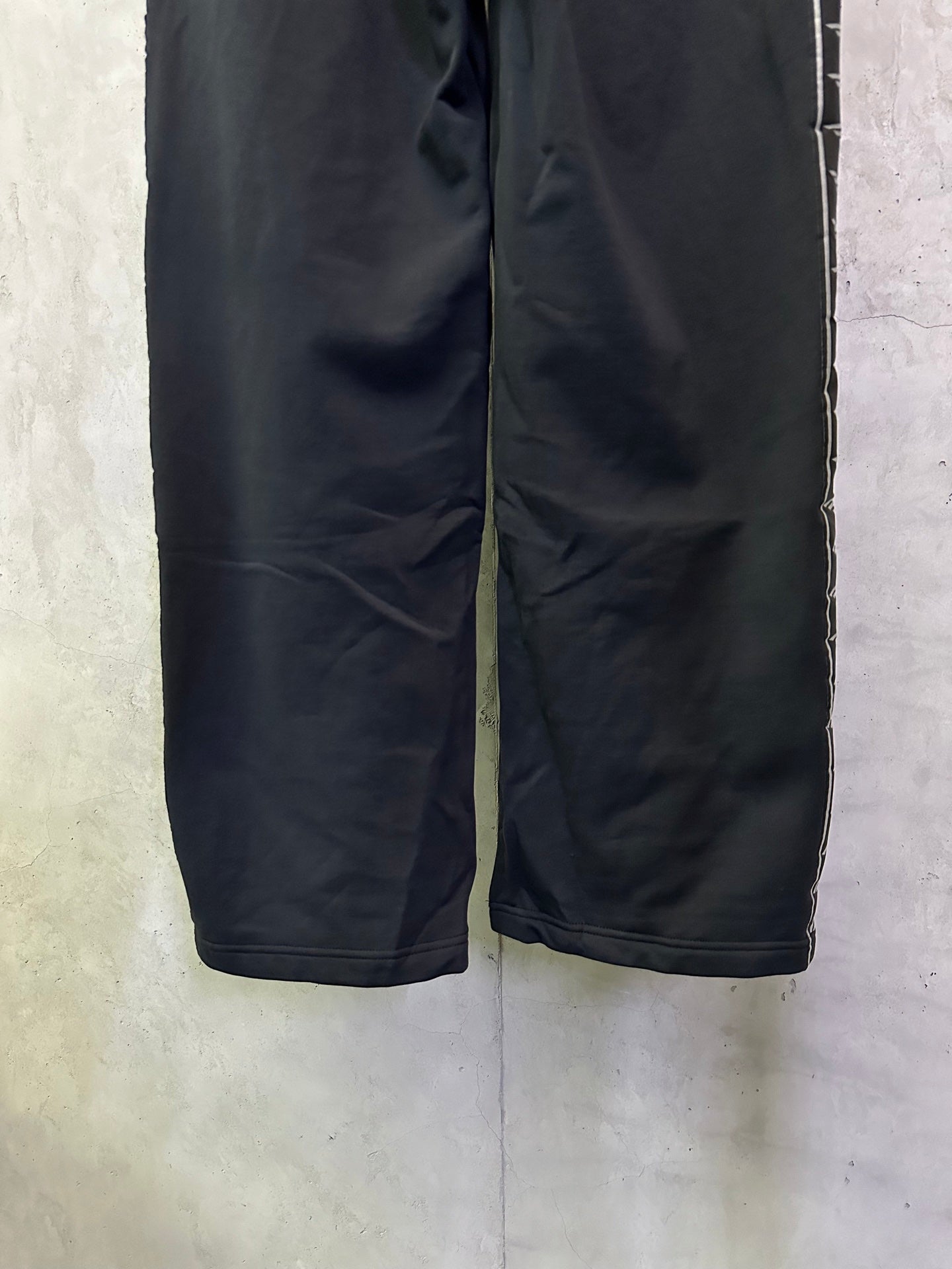 Navy loose-leg track pants with elastic waistband