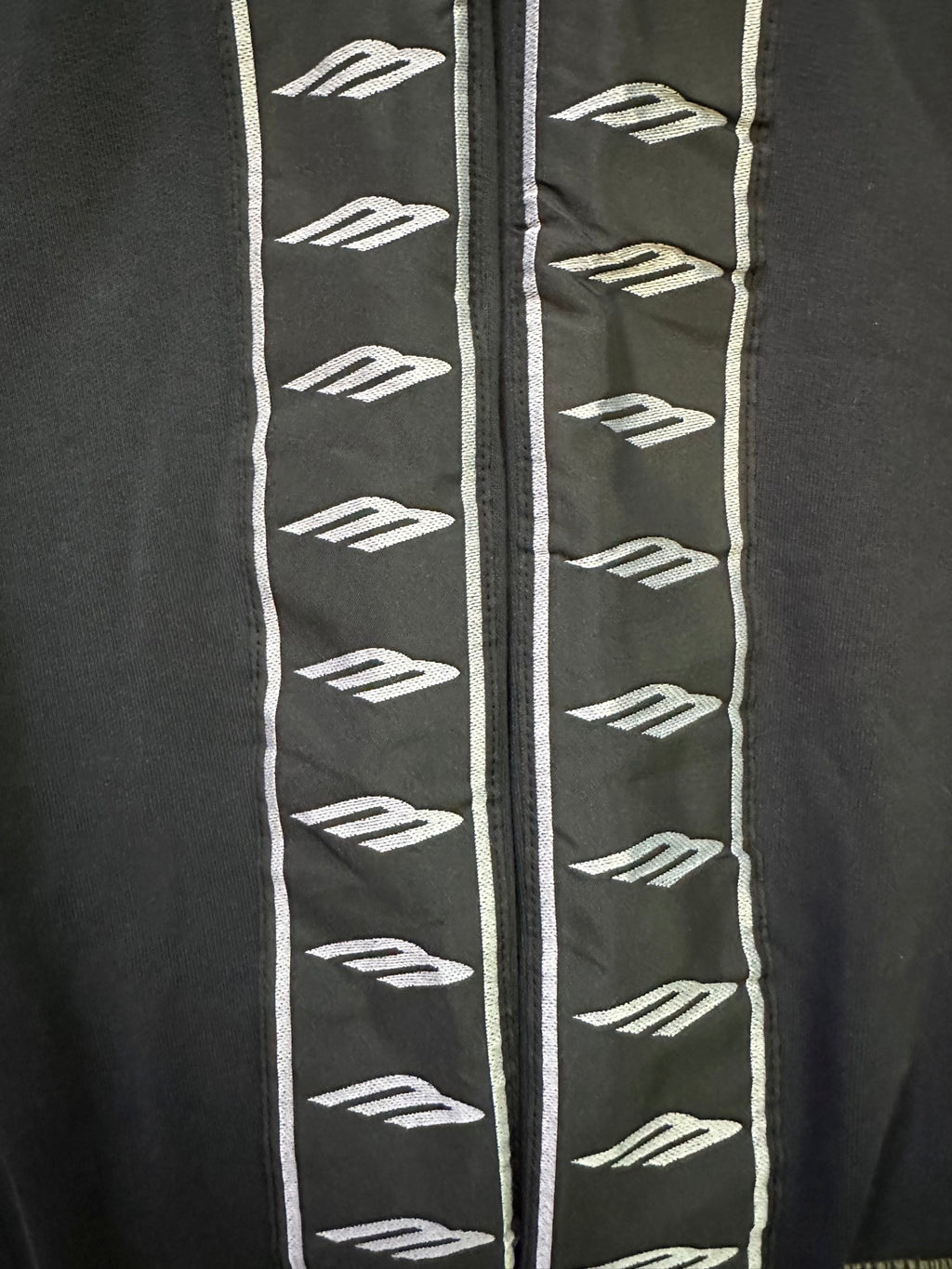 Pants side stripe with repeated BALENCIAGA logo pattern on trim