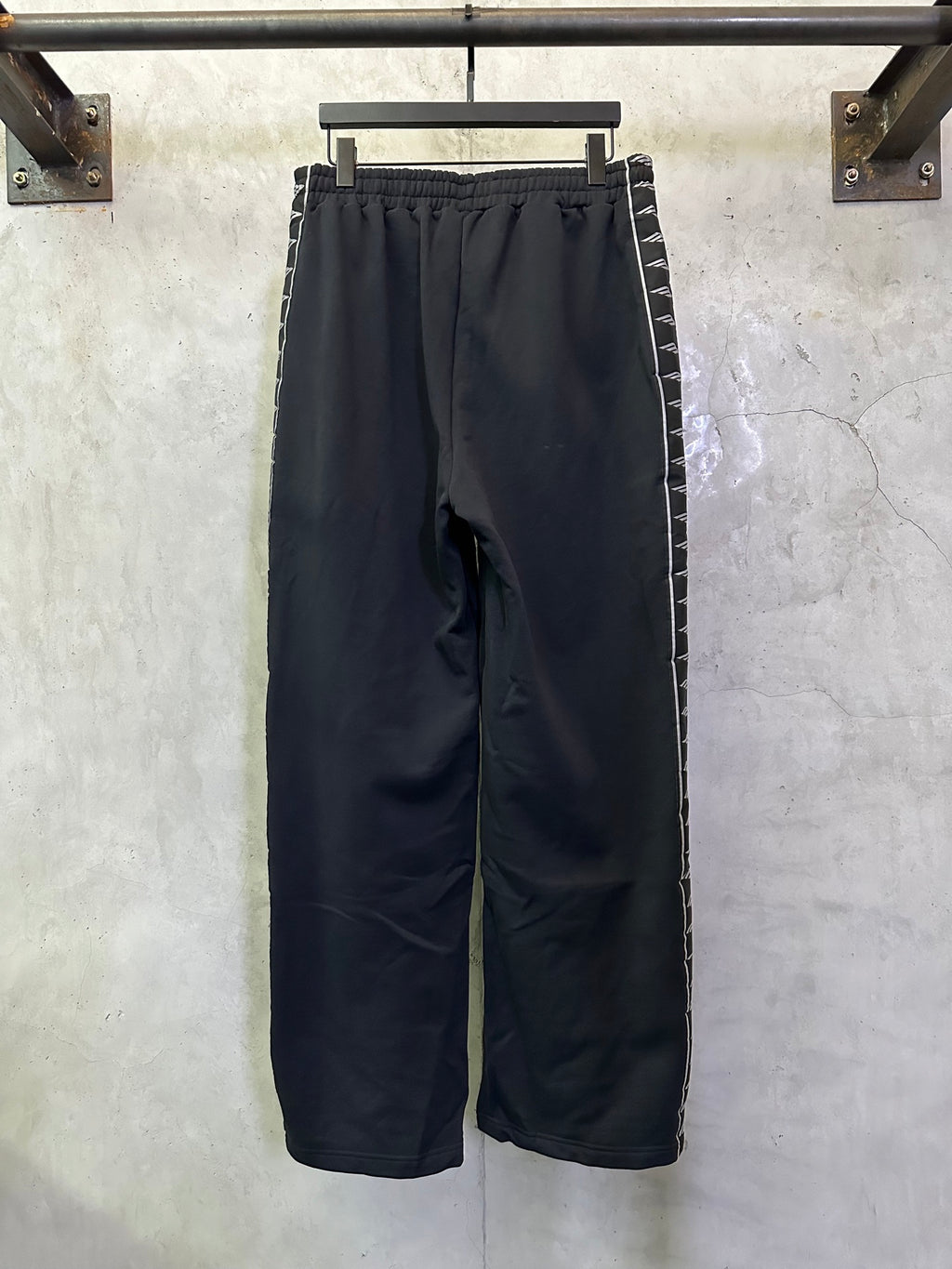 Navy wide-leg track pants with elastic waistband and side stripe panels