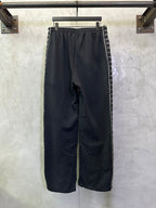 Navy wide-leg track pants with elastic waistband and side stripe panels