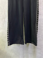 Wide-leg track pants with side stripe trim along the leg seams