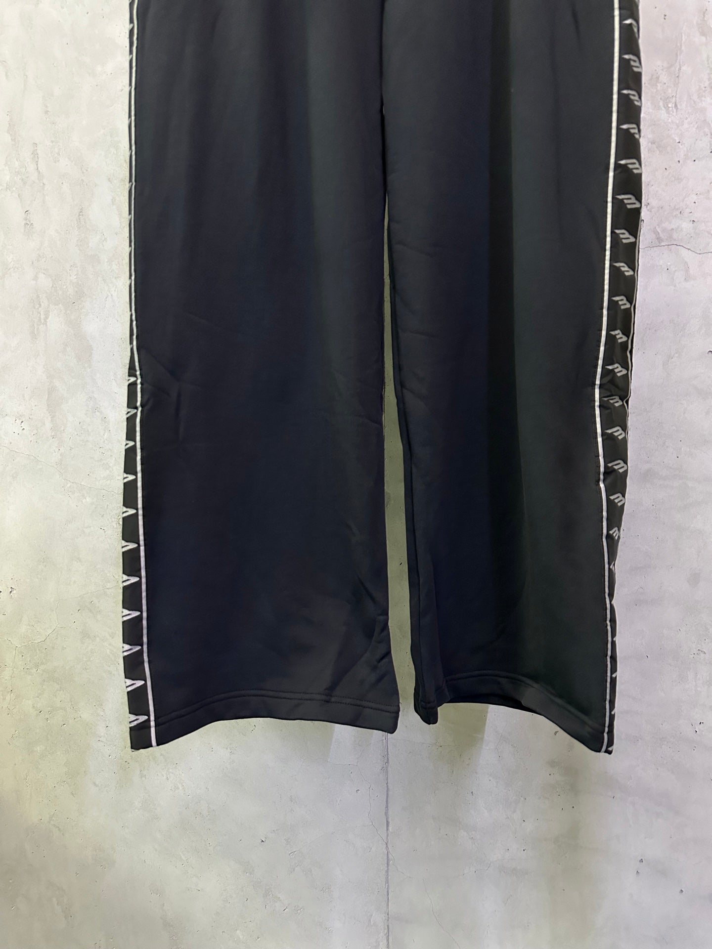Wide-leg track pants with side stripe trim along the leg seams