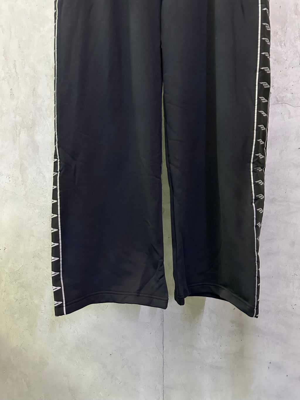 Black track pants with contrast side stripe near hem