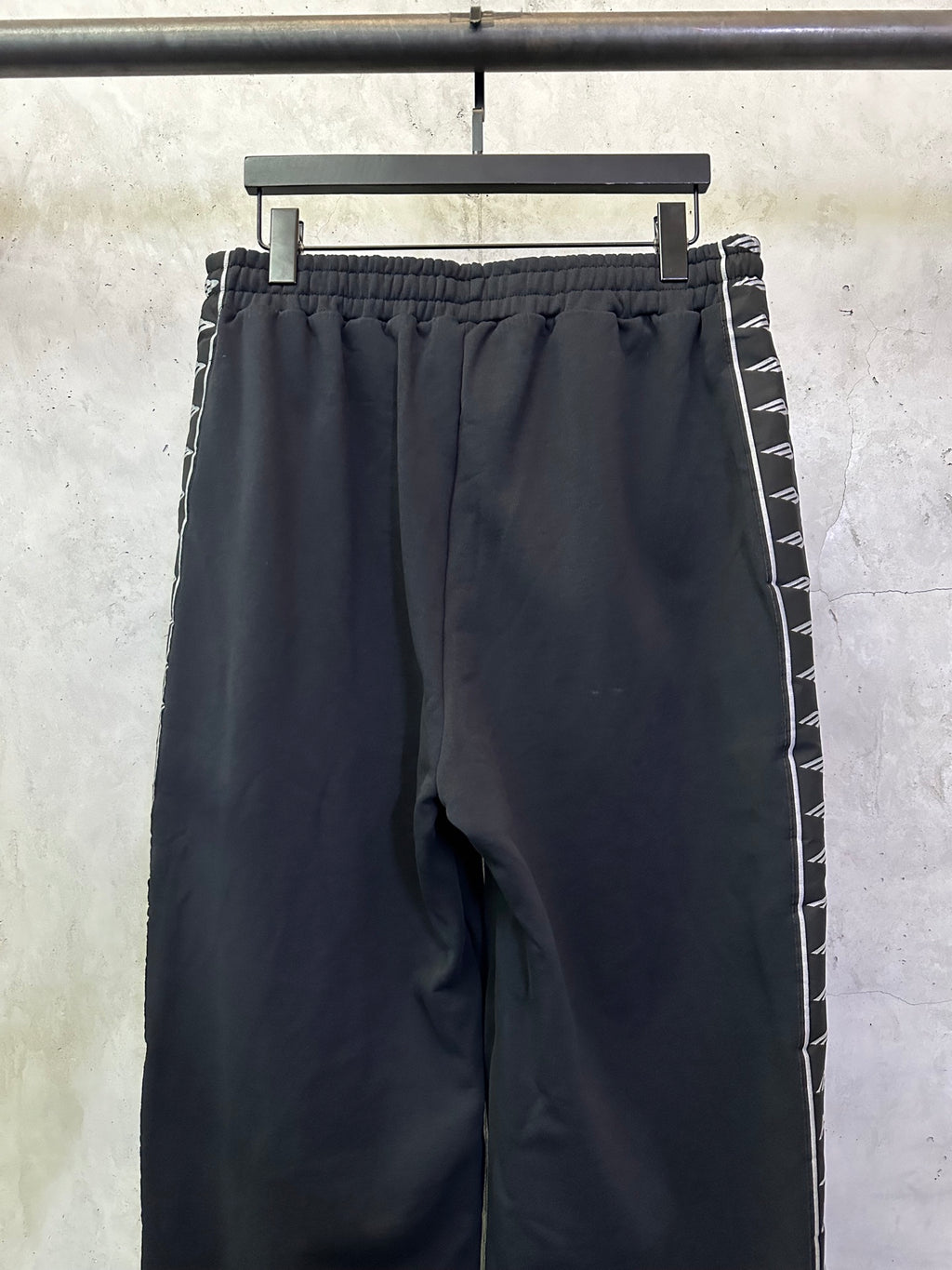 Navy track pants with elastic waistband and side stripe trim